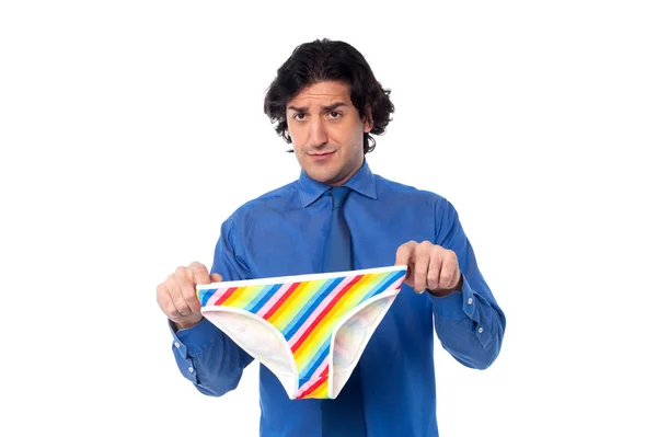 Young man holding underwear — Stock Photo, Image