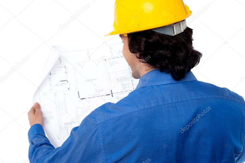 Civil engineer reviewing blueprint