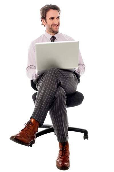 Businessman sitting on the chair with laptop — Stock Photo, Image