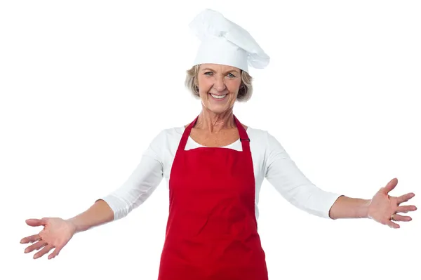 Happy aged chef gesturing welcome — Stock Photo, Image