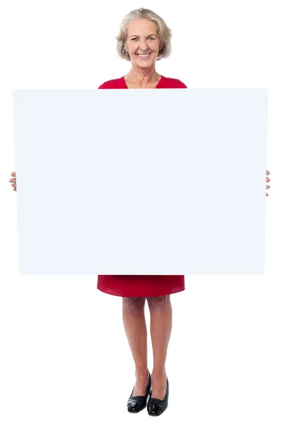 Glamorous woman holding blank ad board — Stock Photo, Image