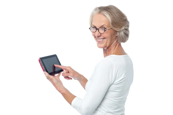 Aged lady operating touch pad device — Stock Photo, Image