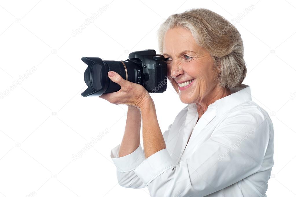 Senior woman taking photos