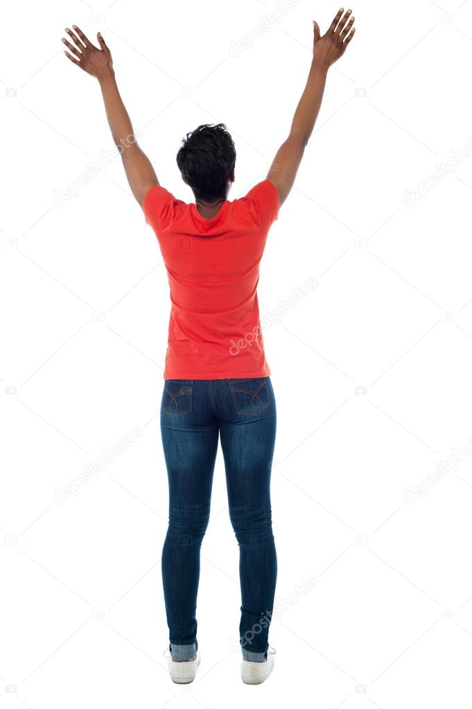 Woman sitting with her arms raised above her head in a yoga pose stock  photo - OFFSET