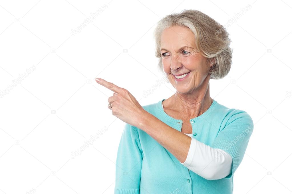 Pretty aged woman pointing at something