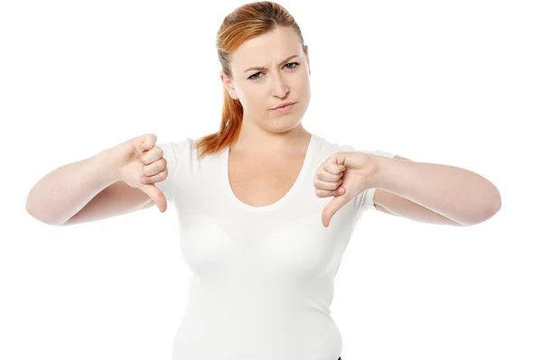 Young women showing thumbs down — Stock Photo, Image