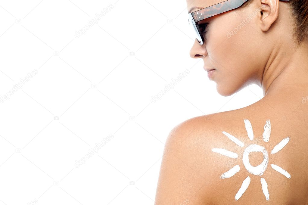 Young woman with sun tan lotion