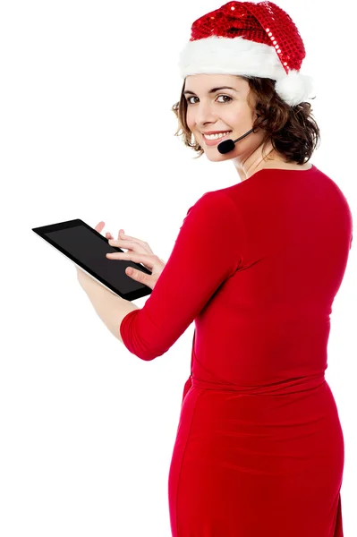 Female santa browsing on her tablet pc — Stock Photo, Image