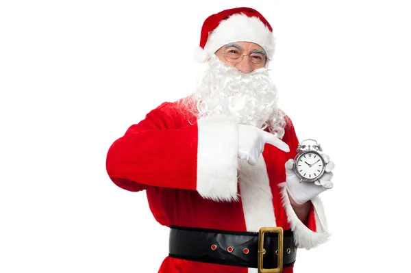 Santa pointing at an antique time piece — Stock Photo, Image