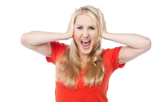 Screaming young woman holding her head — Stock Photo, Image