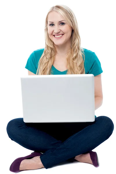 Casual lachende vrouw die op laptop werkt — Stockfoto