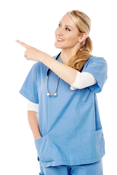 Female doctor pointing at something — Stock Photo, Image