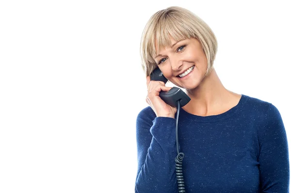 Beautiful lady holding phone receiver — Stock Photo, Image