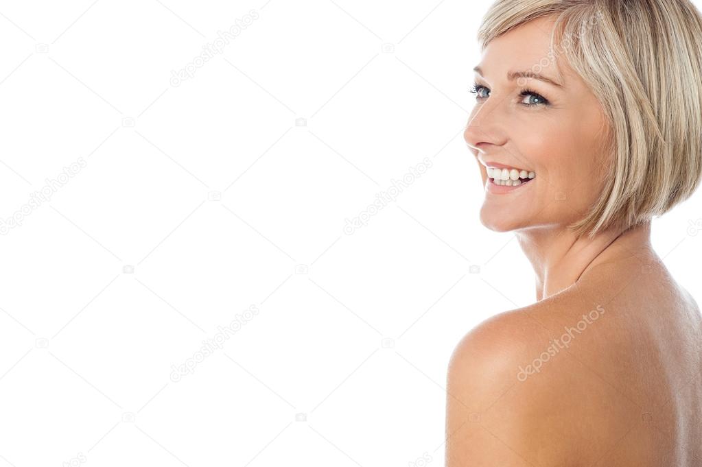 Smiling nude woman looking away