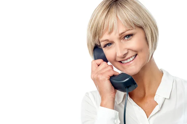 Woman holding phone receiver — Stock Photo, Image