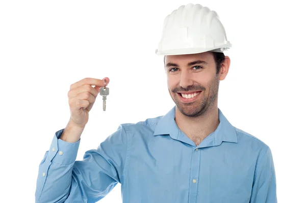Smiling civil engineer holding key Royalty Free Stock Images