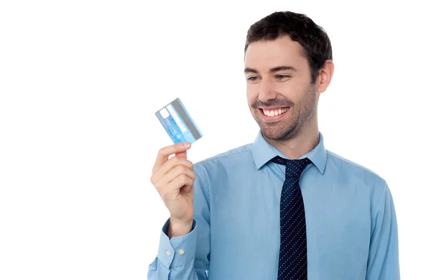 Cheerful businessman holding credit card Royalty Free Stock Photos