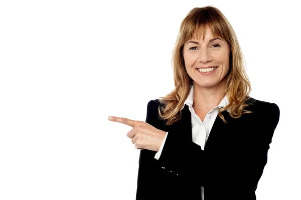 Pretty corporate lady pointing away — Stock Photo, Image