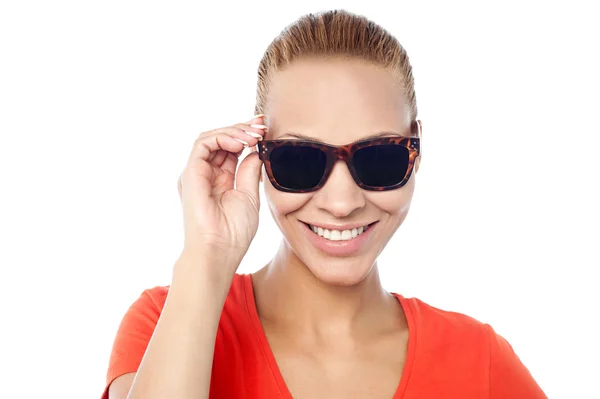 Trendy woman adjusting her sunglasses — Stock Photo, Image