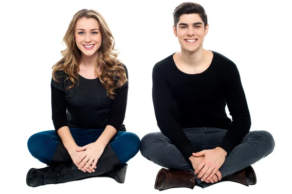 Young love couple sitting on the floor — Stock Photo, Image