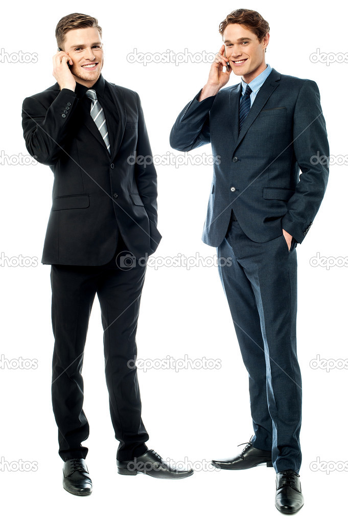 Two businessmen talking on cellphone