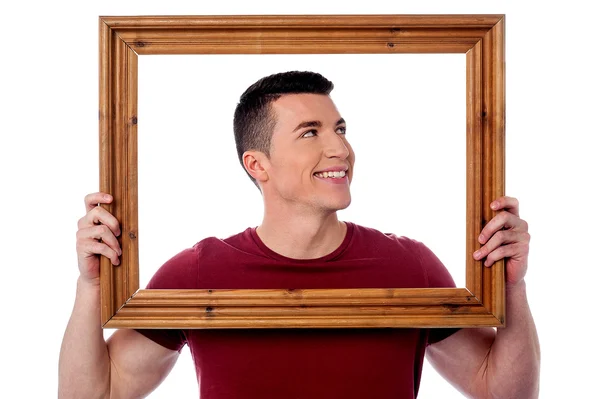 Man holding wooden picture frame — Stock Photo, Image