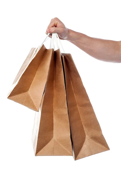 Male hand holding shopping bags — Stock Photo, Image