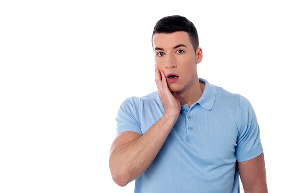 Surprised young man looking at camera — Stock Photo, Image