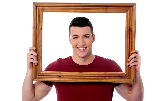 Man holding wooden picture frame — Stock Photo, Image