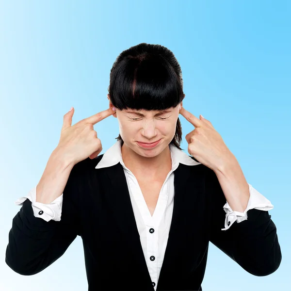 Female employee covering her ears — Stock Photo, Image