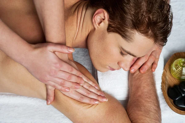 Young man getting massage in spa — Stock Photo, Image
