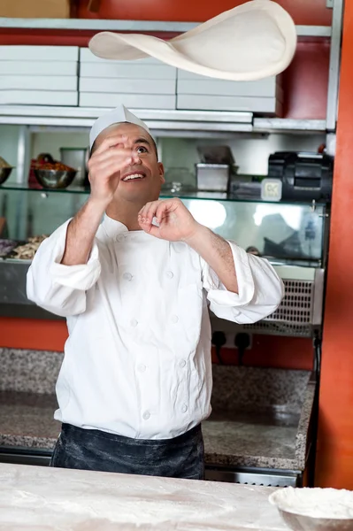 Chef gettando la pasta base della pizza — Foto Stock