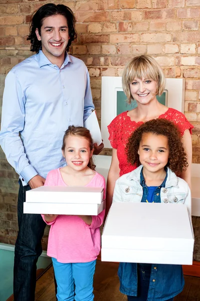 Beautiful little girls holding pizza boxes — Stock Photo, Image