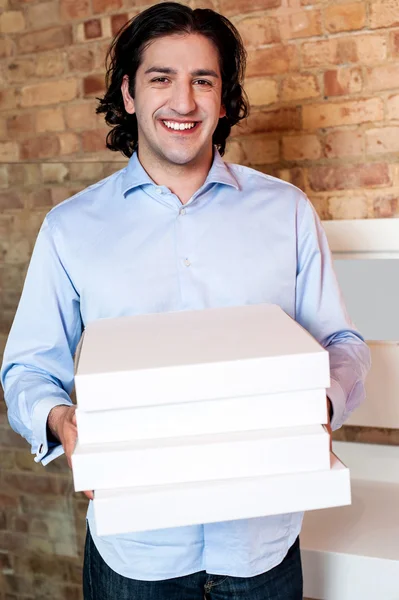 Hombre sonriente sosteniendo cajas de pizza — Foto de Stock