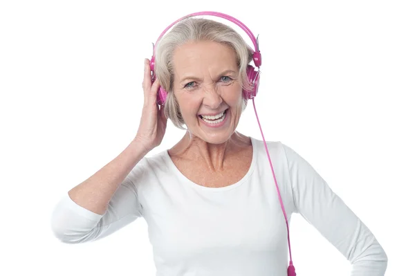 Aged woman listening to music — Stock Photo, Image