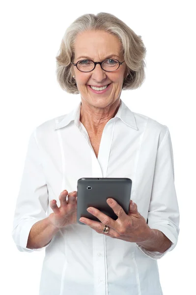 Aged woman using touch pad device — Stock Photo, Image