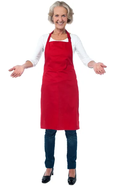 Happy aged chef gesturing welcome — Stock Photo, Image