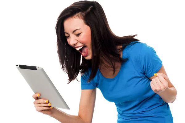 Excited young girl holding touch pad device — Stock Photo, Image