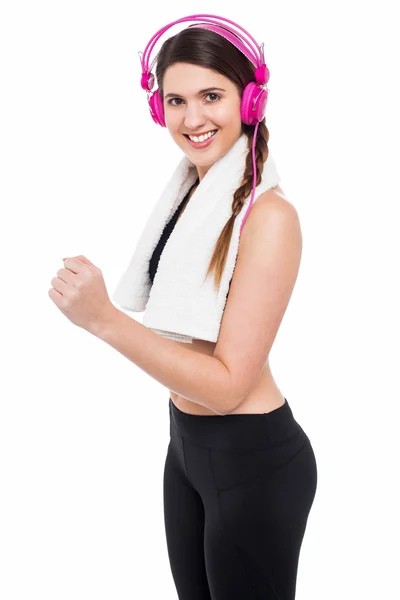 Woman enjoying music while jogging — Stock Photo, Image