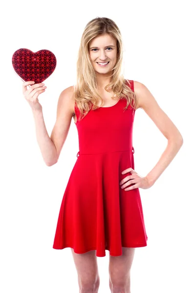 Pretty young girl holding heart shaped gift — Stock Photo, Image