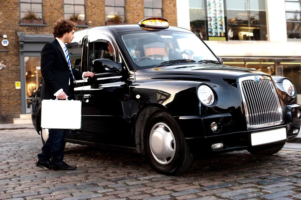 Geschäftsmann interagiert mit Taxifahrer — Stockfoto