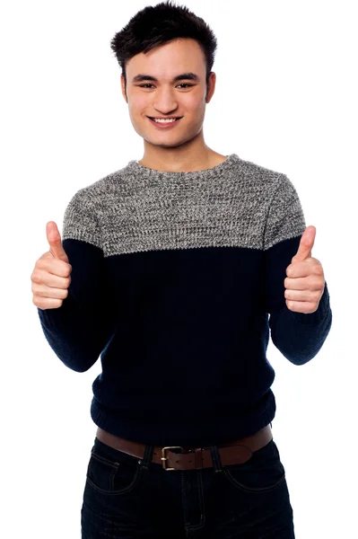 Young casual guy gesturing double thumbs up — Stock Photo, Image