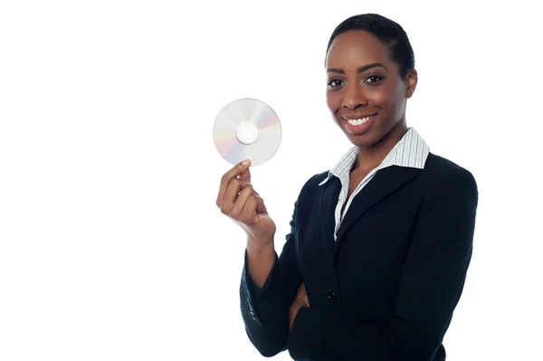 Attractive woman in formals holding CD — Stock Photo, Image