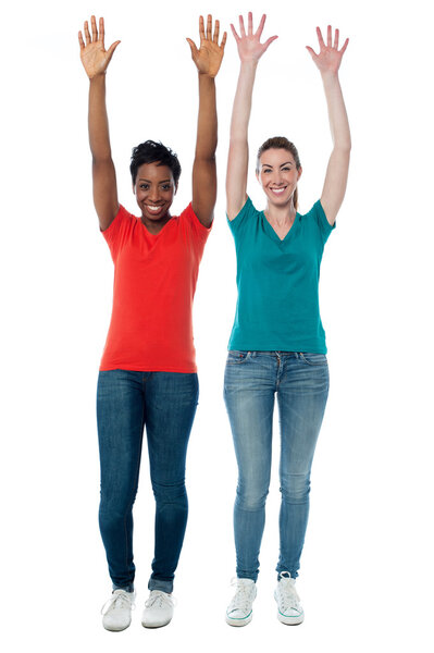 Women raising their arms up in excitement