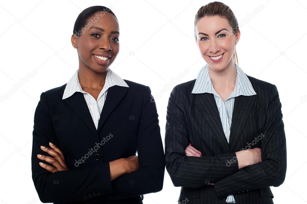 Happy businesswomen with arms crossed