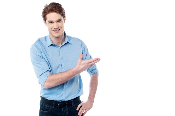 Smiling young man presenting — Stock Photo, Image