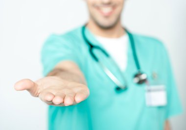 Doctor showing his palm to camera clipart