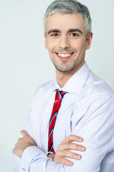 Smiling arms crossed senior businessman — Stock Photo, Image