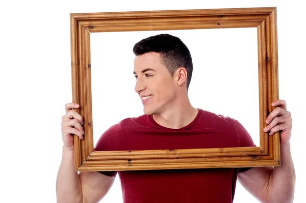 Man holding wooden picture frame — Stock Photo, Image