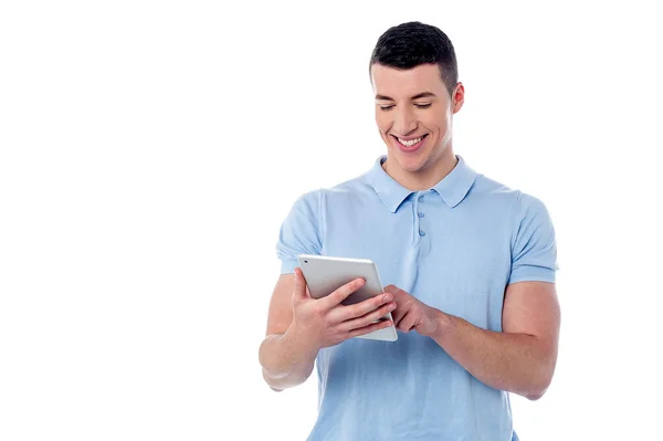 Young man using his tablet pc — Stock Photo, Image